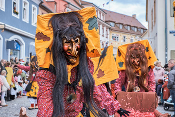 Fototapeta premium Two witches with yellow hoods. Street Carnival in Southern Germany - Black Forest.