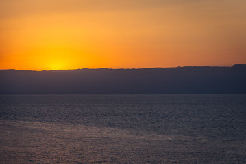 Sunset over Dead Sea salt lake seen from a Jordanian shore