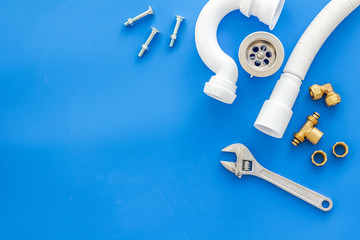 Plumber profession with gear and instruments for repair tubes on blue background top view copyspace