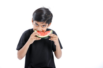 little Indian boy eating watermelon with multiple expressions  