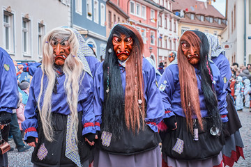 Three witches in violet black robes. Street Carnival in Southern Germany - Black Forest.