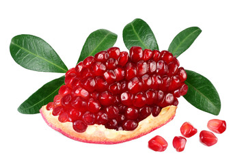 piece of pomegranate with seeds and green leaves isolated on a white background.