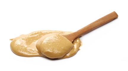 Peanut butter with wooden spoon isolated on white background