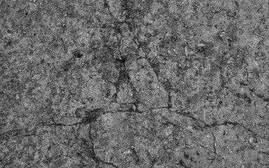 The texture of the old concrete wall with stones, cracks, dust, cracks, roughness. Texture, background