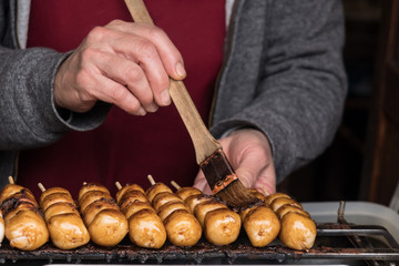Japanese sale person grilling Dango, Japanese dumpling and sweet made from rice flour