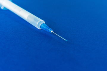 Medical syringe on color background