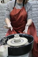 Hands of a Potter creating the clay.  Vessel on the Potter's wheel.
