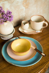 Pastel tone Chinese style ceramic ware bowl, plate, chopstick, vase, cups on wooden table