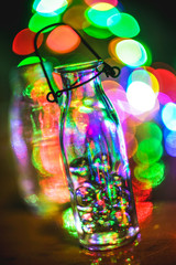 Blurry abstract glass bottle with glass balls. Colorful bokeh nackground