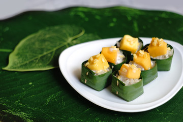 Mango with sticky rice in banana leaves cups, popular Thai dessert