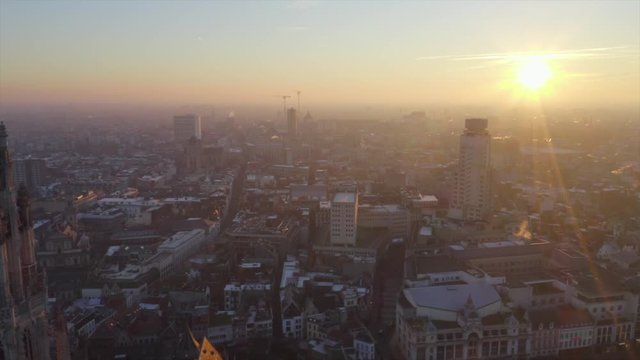 Video shows Cathedral in Antwerp old town in a morning. The city is in orange and the church is the tallest building in Antwerp