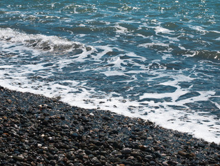 Wave splash on pebble beach