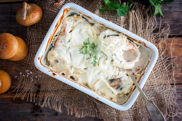 Pink salmon baked in sour cream on a wooden table, top view, horizontal