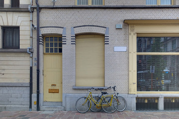 Fototapeta na wymiar Bicycles parking in front of the building, street environment in Belgium