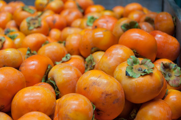 Ripe orange persimmons or fuji fruits background