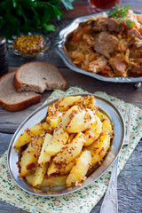 Sliced roasted mustard potatoes with grains, selective focus
