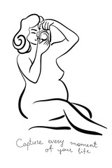 Pregnant woman with a camera