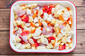 Raw vegetables and turkey fillet in the form, cooked for roasting, top view, horizontal