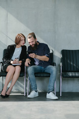 Business colleagues. Break from work. Smiling man with smartphone. Woman with coffee. Copy space.