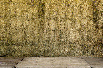 Background of hay bale in warehouse with wooden foreground floor