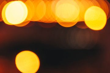 blurred background of bokeh yellow orange lights in the dark