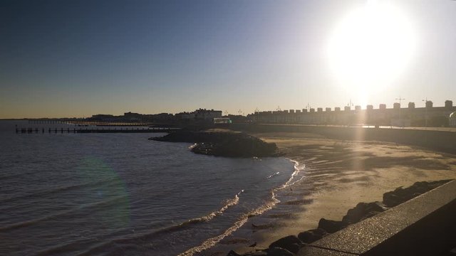 Sunset above a calm beach with pier in Lowstoft, England