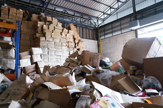Blurry image of poorly organized warehouse with a lot of messy stocks and boxes