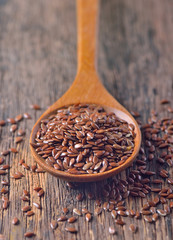 Flax seeds on wooden background