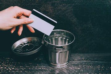credit card going into a garbage bin