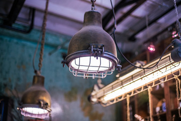 Fototapeta na wymiar Vintage industrial styled lamps hanging from ceiling made from metal material