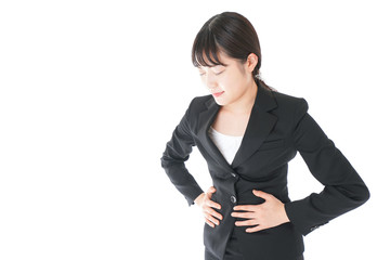 腹痛に苦しむ若いビジネスウーマン