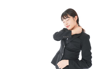Obraz premium 肩こり・腰痛に苦しむ若いビジネスウーマン