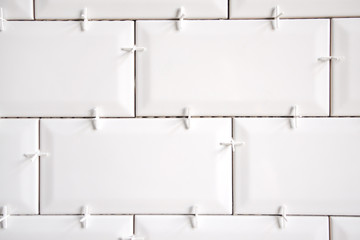 Ceramic tile lying. Installing new subway or metro tiles in bathroom, shower or kitchen back splash...