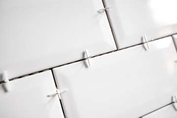 Ceramic tile lying. Installing new subway or metro tiles in bathroom, shower or kitchen back splash...