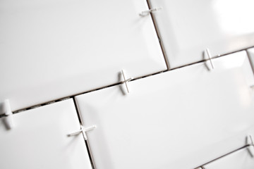 Ceramic tile lying. Installing new subway or metro tiles in bathroom, shower or kitchen back splash...