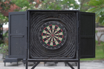 Dart target on black wooden board