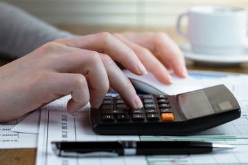 Woman's hands with items for doing business in the office