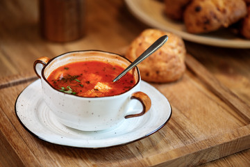 Delicious Tomato tofu  vegetarian soup in a White cup with buns