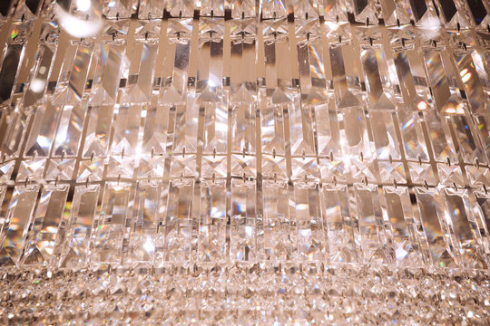Close up image of crystal on chandelier with bokeh background