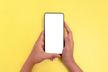 Human hand holding smartphone with white screen background.