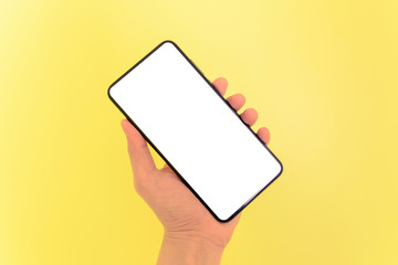 Human hand holding smartphone with white screen background.