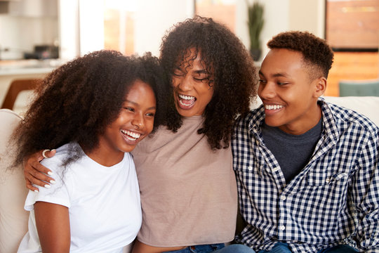 Black teen and young adult brother and sisters relaxing together, close up