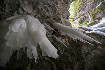 Underground glacier in Glaciers Cave in Apuseni mountains, Scarisoara, Romania. Big icicles holding on ceiling in the cave