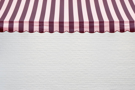 Red stripes awning with white brick wall background