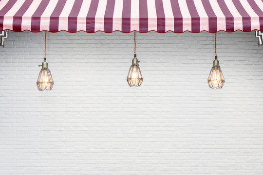 Red Stripes Awning With White Brick Wall Background