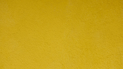 Texture of yellow plastered wall for background.