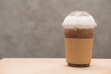 Iced cocoa in takeaway cup on table