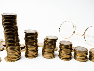 Row of coins,glasses on table, finance and banking concept