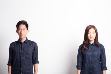 Couple standing on different side with upset looks on their faces