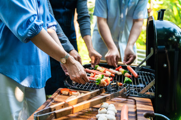 Group of people picnic party in home garden with bbq food